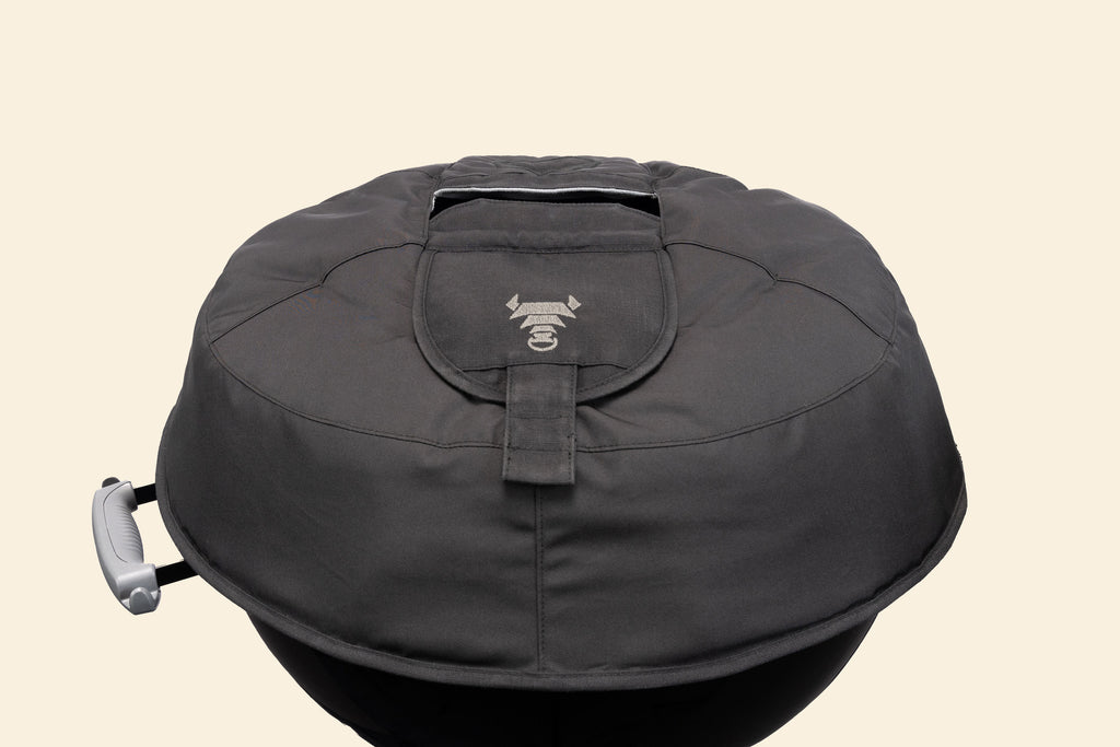 The Woolly Bully resting on a Weber kettle lid without the handle, to show the vent flaps