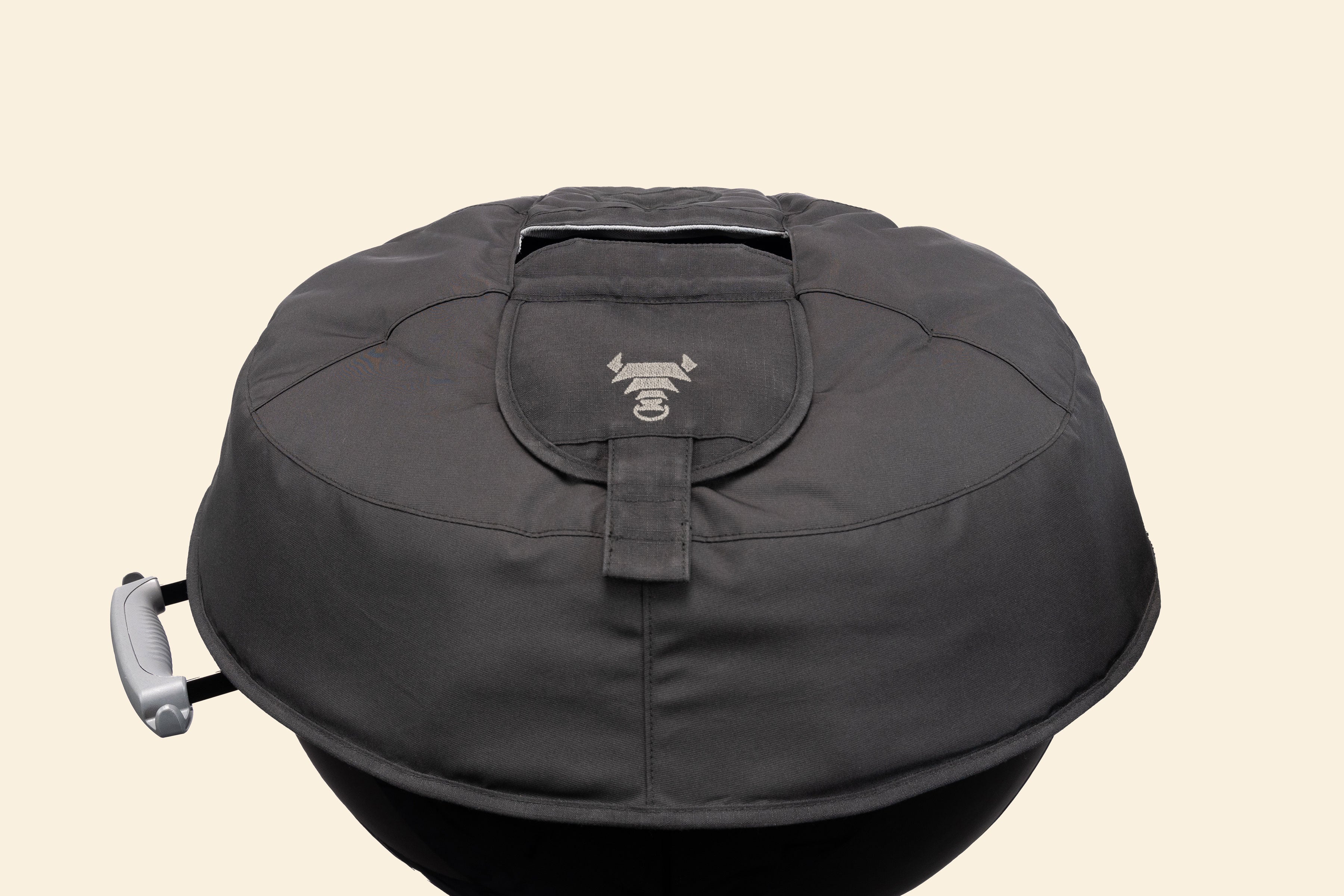 The Woolly Bully resting on a Weber kettle lid without the handle, to show the vent flaps