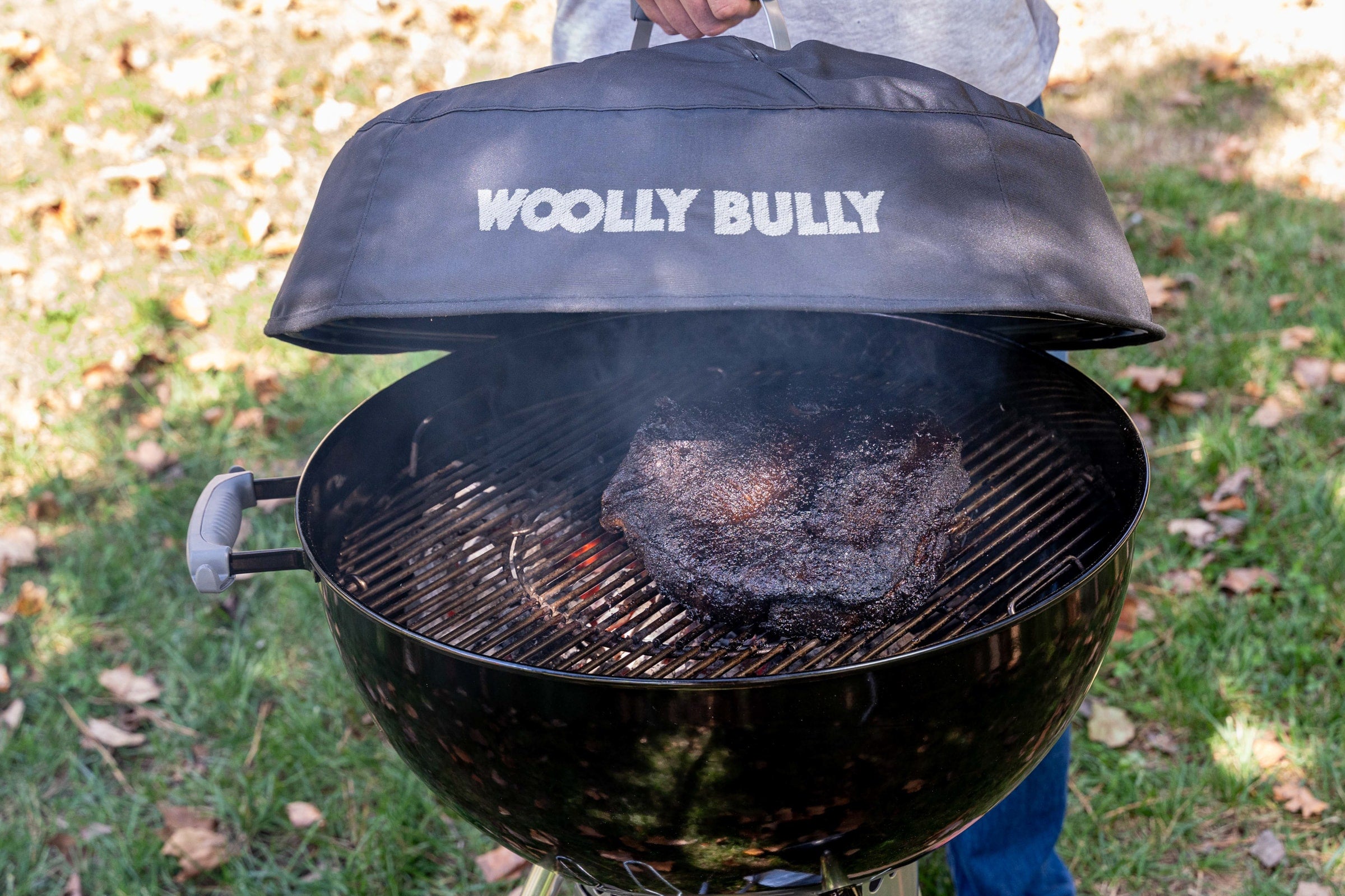A brisket that has cooked all day on a Weber grill with a Woolly Bully Insulated Grill Cover