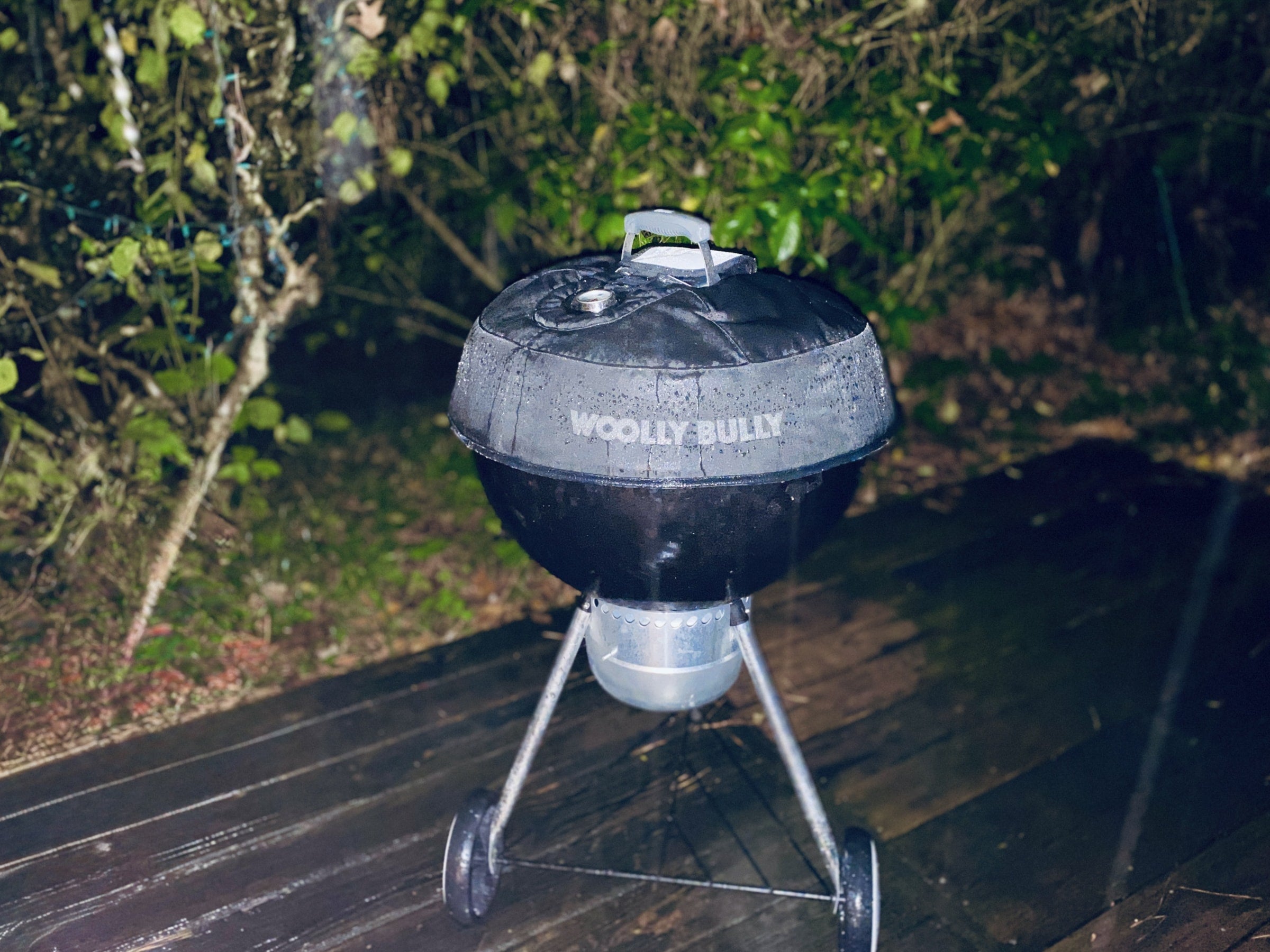 A Weber kettle grill with a Woolly Bully cooking in the rain.